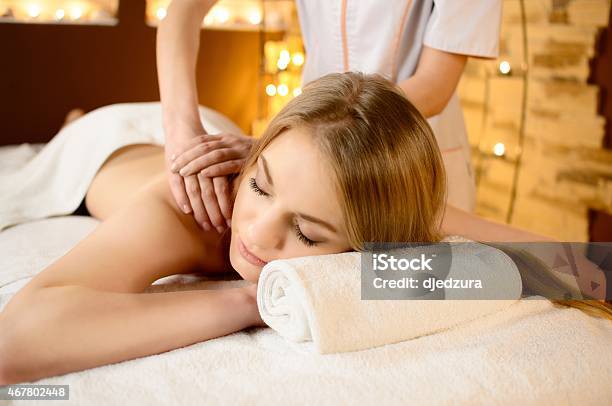 Young Beautiful Woman Lying On A Massage Table Stock Photo - Download Image Now - Back, Human Face, Rear View