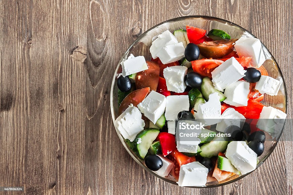 Greek Salad on wooden background Greek salad in bowl on wooden table with copy space 2015 Stock Photo