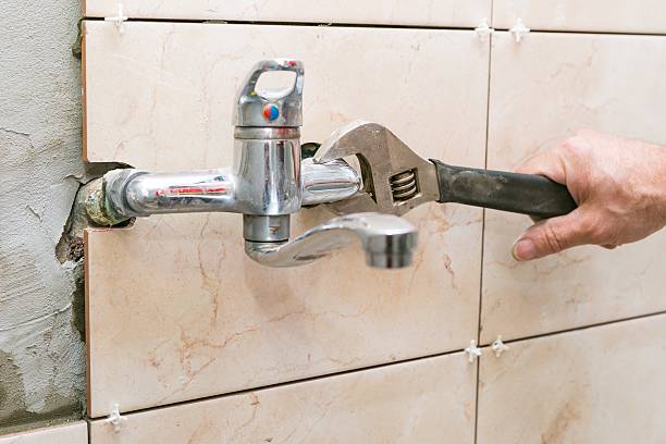 istock Water fixing - plumber hands with wratch fix tap 467808576