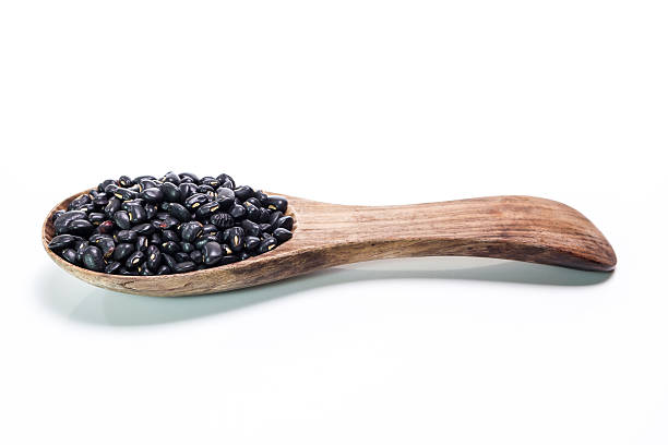 istock black beans in wooden spoon 467808664