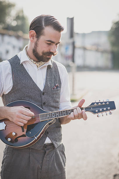 istock handsome big moustache hipster man playing mandolin 467810552