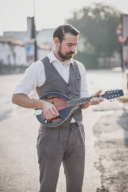 istock handsome big moustache hipster man playing mandolin 467810554