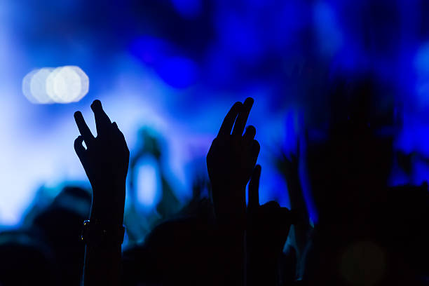 istock People taking photographs with touch smart phone during a music 467810808