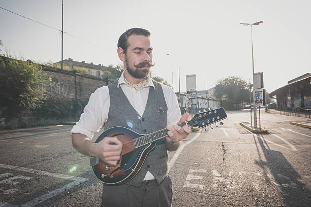 istock handsome big moustache hipster man playing mandolin 467810852