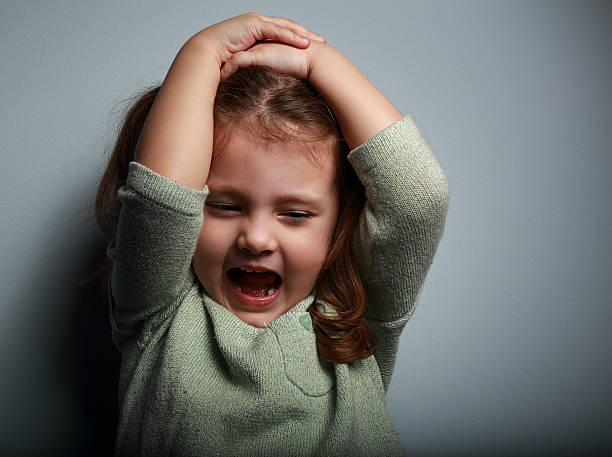 istock Angry kid girl shouting with open mouth and holding hands 467811504
