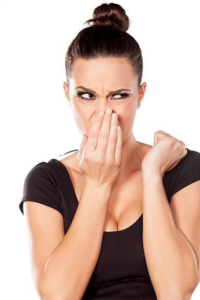 istock woman checks her breath 467811618