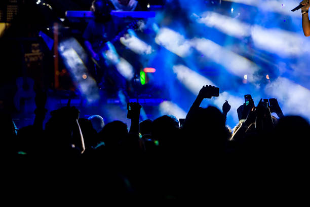 istock People taking photographs with touch smart phone during a music 467813880
