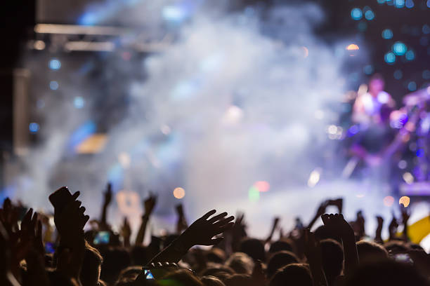 istock People taking photographs with touch smart phone during a music 467813918