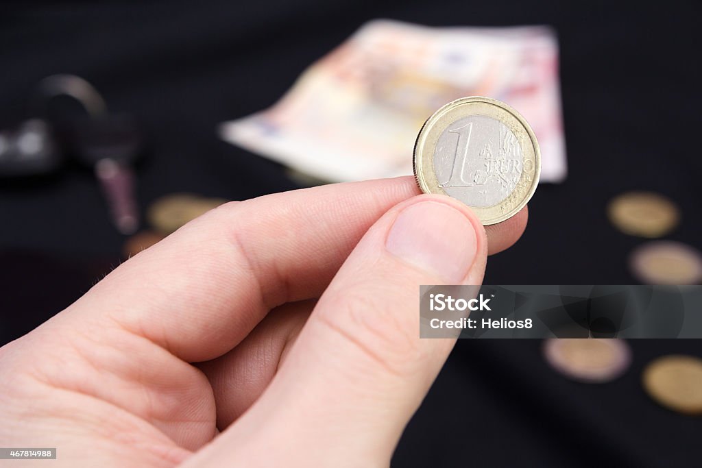 mans hand holding money man's hand holding money on the black background 2015 Stock Photo
