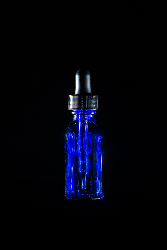 E-juice dropper bottle on a black background