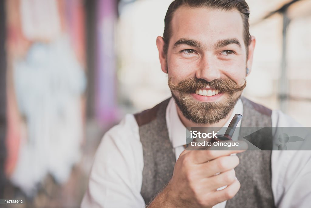 handsome big moustache hipster man smoking pipe handsome big moustache hipster man smoking pipe in the city 2015 Stock Photo