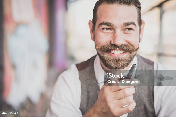 Handsome Big Moustache Hipster Man Smoking Pipe Stock Photo - Download Image Now - 2015, Adult, Beard