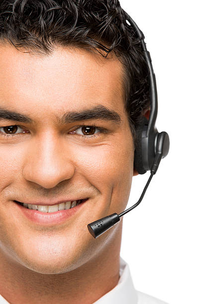 A customer service representative taking calls at a call center. She is wearing a telephone headset. Set on a white background.