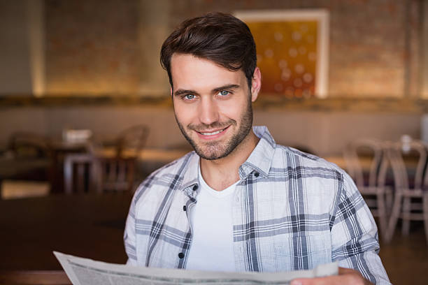 istock Young man reading the newspaper 467819564