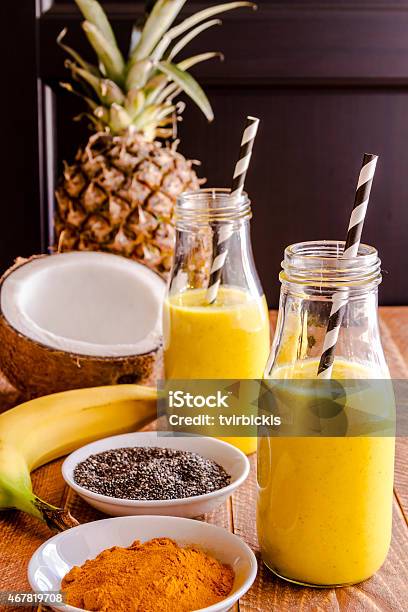 Pineapple Banana Coconut Turmeric And Chia Seed Smoothies Stock Photo - Download Image Now