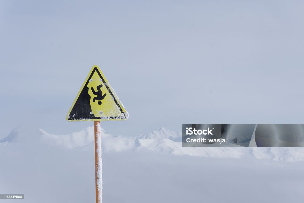 danger steep cliff mountain sign danger steep cliff mountain sign, mountains and cloudy sky 2015 Stock Photo