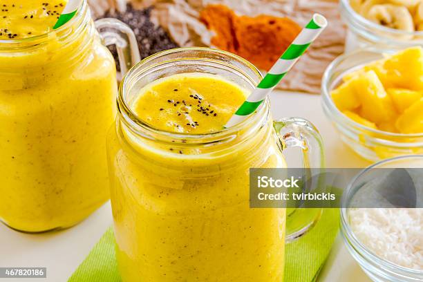 Pineapple Banana Coconut Turmeric And Chia Seed Smoothies Stock Photo - Download Image Now