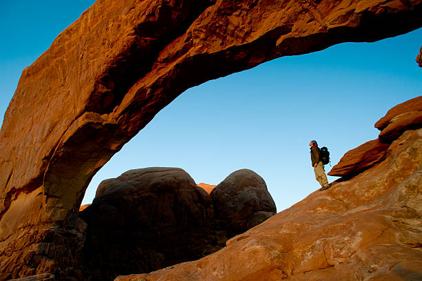 istock Male hiker  under arch looking at view 467820330