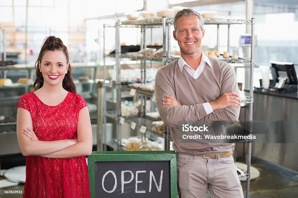 Cafe owners smiling at the camera Cafe owners smiling at the camera at the cafe 16-17 Years Stock Photo