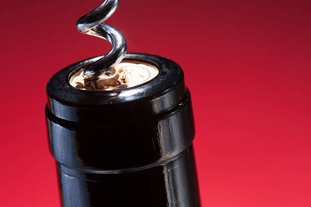 istock Corkscrew top of wine bottle closeup on red 467824374
