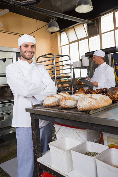 istock Smiling baker looking at camera with arms crossed 467825396