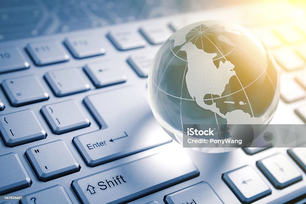 global technology global technology - Blue glass Globe  (america map)   and Computer Keyboard Backgrounds Stock Photo