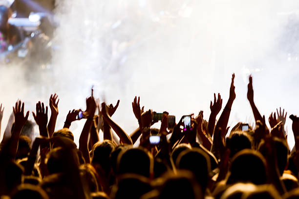 istock People taking photographs with touch smart phone during a music 467829492