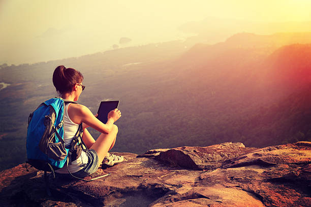istock hiking woman use digital tablet on mountain peak 467829972