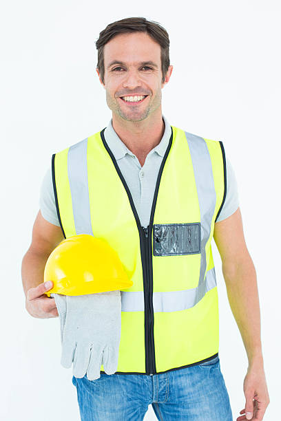 istock Confident construction worker holding gloves and hardhat 467830066