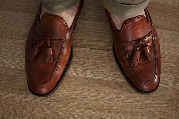 istock Sockless legs in pants and loafers 467831400