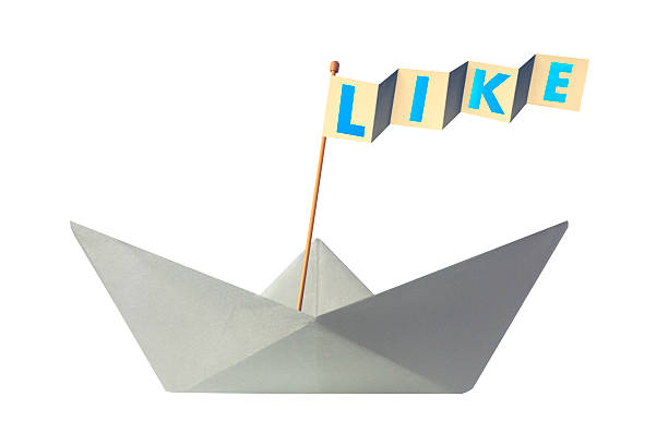istock Origami paper boat with flag writing LIKE 467833080
