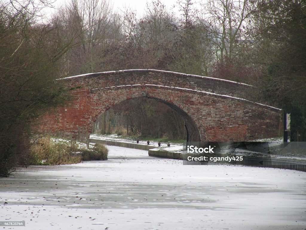 brick bridge over a frozen canal a brick bridge over a frozen canal 2015 Stock Photo