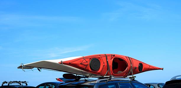 istock car with kayak canoe on top blue sky. Active lifestyle 467838539