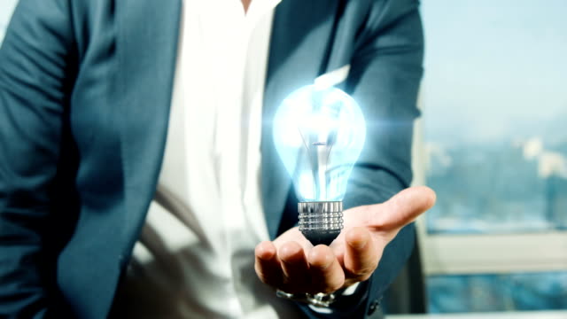 Businessman Holding Light Bulb | Idea