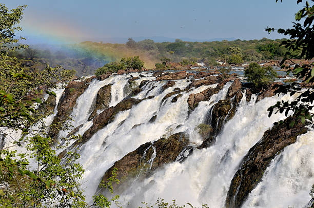 Sunrise at the Ruacana waterfall, Namibia Ruacana waterfalls on the border of Namibia and Angola at sunrise, Dragon flies visible everywhere. kaokoveld stock pictures, royalty-free photos & images