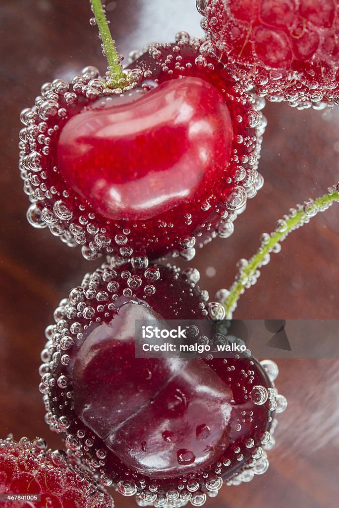 Bubbly Fruits Sweet, fresh and healthy cherries with delicious raspberries. Bubble Stock Photo