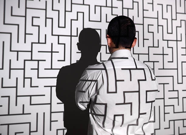 Businessman standing in front of labyrinth