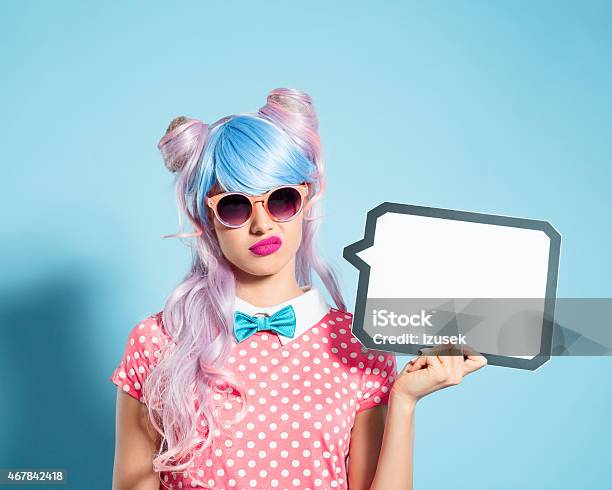 Pink Hair Manga Style Girl Holding Speech Bubble Stock Photo - Download Image Now - Disgust, Human Face, Young Women