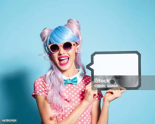 Happy Pink Hair Manga Style Girl Holding Speech Bubble Stock Photo - Download Image Now