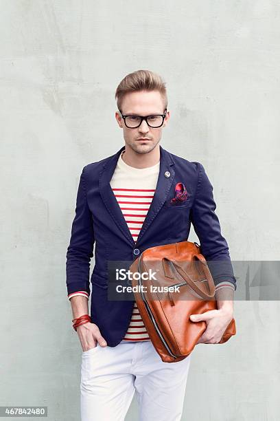 Fashionable Blonde Young Man Holding Bag Stock Photo - Download Image Now - 2015, Adult, Adults Only