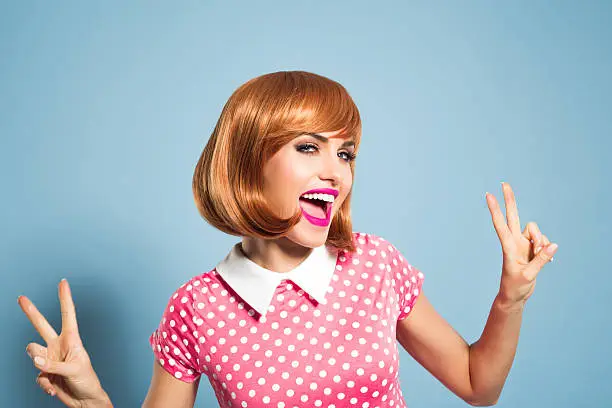 Photo of Excited red hair young woman wearing polka dot dress