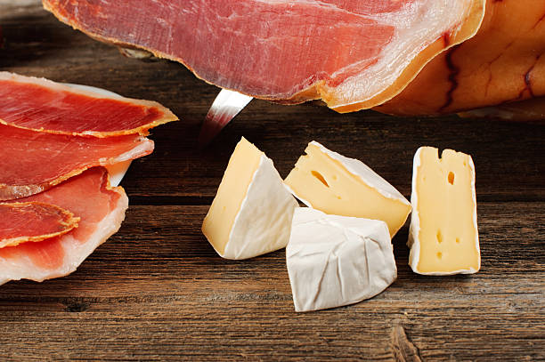istock Parma ham (jamon) sliced on a wooden board. 467842870