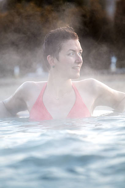 istock Young woman relaxing in thermal pool. 467845040