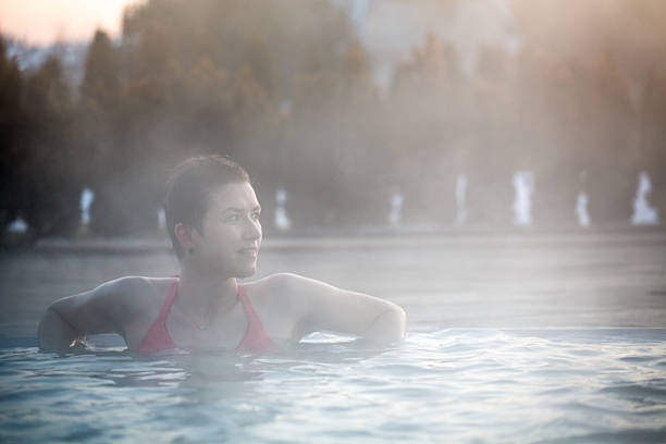 istock Young woman relaxing in thermal pool. 467845046