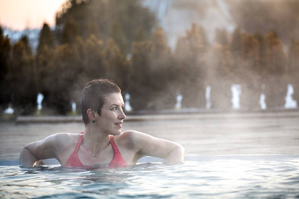 istock Young woman relaxing in thermal pool. 467845048