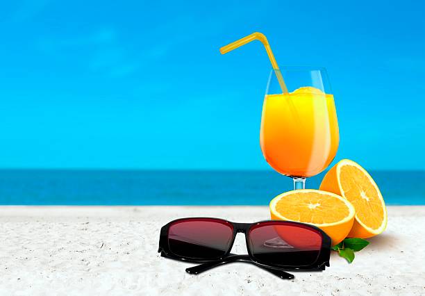 istock Orange Juice and Sunglasses at the Beach 467848033