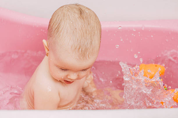istock baby playing in the water 467848440