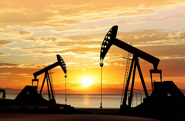 silhouette of oil pumps stock photo