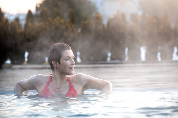 istock Young woman relaxing in thermal pool. 467849450