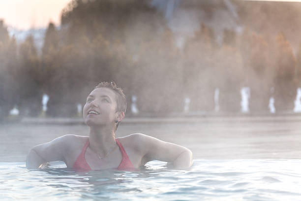 istock Young woman relaxing in thermal pool. 467849744